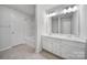 Bright bathroom featuring double vanity, updated mirror, and bathtub with shower at 6814 Piper Thorn Way, Indian Land, SC 29707