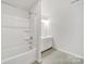Bright bathroom with a tub/shower combo, white vanity, and tiled floors at 6814 Piper Thorn Way, Indian Land, SC 29707