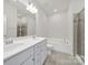Bathroom featuring a double vanity, soaking tub, and tiled shower at 6814 Piper Thorn Way, Indian Land, SC 29707