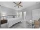 Bedroom with a ceiling fan, a view to the bathroom, and neutral wall color at 6814 Piper Thorn Way, Indian Land, SC 29707