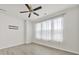 Bright bedroom with large windows, modern ceiling fan, and light gray wood flooring at 6814 Piper Thorn Way, Indian Land, SC 29707