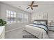 Comfortable bedroom with a queen bed, carpeted floors, and three windows allowing ample natural light at 6814 Piper Thorn Way, Indian Land, SC 29707