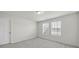 A bright bedroom featuring carpeted floors and natural light from two windows with blinds at 6814 Piper Thorn Way, Indian Land, SC 29707