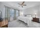 Bedroom with a ceiling fan, two windows with decorative curtains, and neutral wall color at 6814 Piper Thorn Way, Indian Land, SC 29707