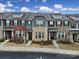 Charming townhome featuring a brick facade, multiple windows, and a well-manicured front yard at 6814 Piper Thorn Way, Indian Land, SC 29707