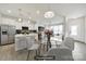 Bright kitchen with stainless steel appliances, quartz countertops, and an open layout to the living area at 6814 Piper Thorn Way, Indian Land, SC 29707