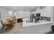 Modern eat-in kitchen features white cabinets, stainless appliances, gray backsplash and updated countertops at 6814 Piper Thorn Way, Indian Land, SC 29707