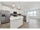Kitchen with gray backsplash and modern stainless steel appliances, including a dishwasher at 6814 Piper Thorn Way, Indian Land, SC 29707