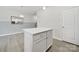 White kitchen island featuring stainless steel hardware and white quartz countertop at 6814 Piper Thorn Way, Indian Land, SC 29707