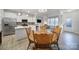 Bright kitchen overlooking a spacious dining area with a wooden table at 6814 Piper Thorn Way, Indian Land, SC 29707