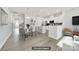 Modern kitchen with white cabinets, stainless steel appliances, and an island with bar seating at 6814 Piper Thorn Way, Indian Land, SC 29707