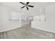 Bright, open-concept living space with modern ceiling fan and light gray wood flooring at 6814 Piper Thorn Way, Indian Land, SC 29707
