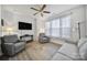 Bright living room with ceiling fan and large windows at 6814 Piper Thorn Way, Indian Land, SC 29707