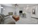 This living room features neutral walls, carpet, ceiling fan, lamps and natural light at 6814 Piper Thorn Way, Indian Land, SC 29707