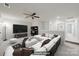 Spacious living room with a white sofa, ceiling fan, tv and plush ottoman at 6814 Piper Thorn Way, Indian Land, SC 29707