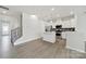 Open-concept space with staircase and a modern kitchen that features stainless steel appliances at 6814 Piper Thorn Way, Indian Land, SC 29707