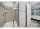 Walk-in shower featuring glass doors and a view to the bedroom at 6814 Piper Thorn Way, Indian Land, SC 29707