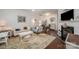 Open concept living space featuring a fireplace, hardwood floors, and comfortable seating at 706 Cherryfield Pl, Rock Hill, SC 29732