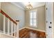 Bright entry way with hardwood floors, white trim, and a stylish light fixture at 7541 Thorn Creek Ln, Tega Cay, SC 29708