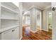 Hallway with built in shelving, hardwood floors, and neutral paint color at 7541 Thorn Creek Ln, Tega Cay, SC 29708