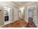 Hallway with multiple doors and views into rooms with hardwood floors at 7541 Thorn Creek Ln, Tega Cay, SC 29708