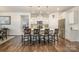 Stylish kitchen island features white cabinets, quartz countertops, pendant lighting, and bar seating at 810 Latrobe Dr, Iron Station, NC 28080