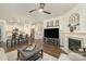 Open-concept living space featuring hardwood floors, fireplace, and seamless transition to modern kitchen at 810 Latrobe Dr, Iron Station, NC 28080