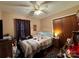 Cozy bedroom showcasing a ceiling fan and a wooden closet door at 8522 Stonehurst Dr, Charlotte, NC 28214