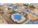Community pool aerial view showing pool cover, clubhouse, and parking lot at 8651 Shadetree St, Huntersville, NC 28078