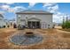 Back exterior view of home with patio, screened porch, shed, and fire pit at 8651 Shadetree St, Huntersville, NC 28078