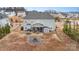 Aerial view of the back of the house, showcasing a fire pit and shed at 8651 Shadetree St, Huntersville, NC 28078