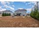 Expansive backyard view highlighting fire pit, patio, and screened-in porch at 8651 Shadetree St, Huntersville, NC 28078