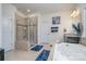 The bathroom has a glass shower, soaking tub, tiled floors, and dual sink vanities with granite counters at 8651 Shadetree St, Huntersville, NC 28078