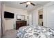This bedroom features a ceiling fan, large bed, dresser, TV, and access to an ensuite bathroom at 8651 Shadetree St, Huntersville, NC 28078