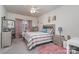 This bedroom features a large bed, a dresser, mirror, pink accents, and a ceiling fan for added comfort at 8651 Shadetree St, Huntersville, NC 28078