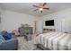 Bedroom with a ceiling fan, tv and fur rug with gray couch at 8651 Shadetree St, Huntersville, NC 28078