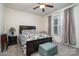 Comfortable bedroom with a large bed, ceiling fan, bedside table with lamp, and large window at 8651 Shadetree St, Huntersville, NC 28078