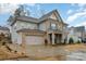 Beautiful two-story home with a brick and siding exterior, complemented by blue shutters and a well-manicured lawn at 8651 Shadetree St, Huntersville, NC 28078