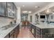 Modern kitchen with granite countertops, stainless steel appliances and dark cabinets at 8651 Shadetree St, Huntersville, NC 28078