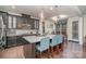 Kitchen island with granite countertop, dark cabinets and bar stool seating at 8651 Shadetree St, Huntersville, NC 28078