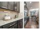 Modern kitchen with black cabinets, stainless steel appliances, and granite countertops at 8651 Shadetree St, Huntersville, NC 28078