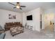Comfortable living room with TV and doorway to laundry room at 8651 Shadetree St, Huntersville, NC 28078