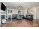 Spacious living room with a fireplace, a large black sectional, and a staircase at 8651 Shadetree St, Huntersville, NC 28078