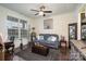 Cozy living room with gray sofa, rug, plants and a large window for natural light at 8651 Shadetree St, Huntersville, NC 28078