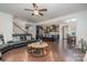 Open floorplan with a large black sectional connecting the living room and kitchen at 8651 Shadetree St, Huntersville, NC 28078