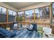 Relaxing screened porch with string lights and comfortable blue cushioned seating at 8651 Shadetree St, Huntersville, NC 28078