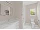 Bathroom featuring white cabinets, a marble countertop, tiled shower, and a toilet at 8705 Moody Rd, Charlotte, NC 28215