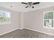 Bedroom featuring neutral paint, gray flooring and two large windows for lots of natural light at 8705 Moody Rd, Charlotte, NC 28215