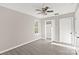 Bright bedroom features a ceiling fan, wood-look floors, and a closet for ample storage at 8705 Moody Rd, Charlotte, NC 28215