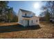 Exterior rear view of home featuring vinyl siding, a back entry door, and a large yard at 8705 Moody Rd, Charlotte, NC 28215